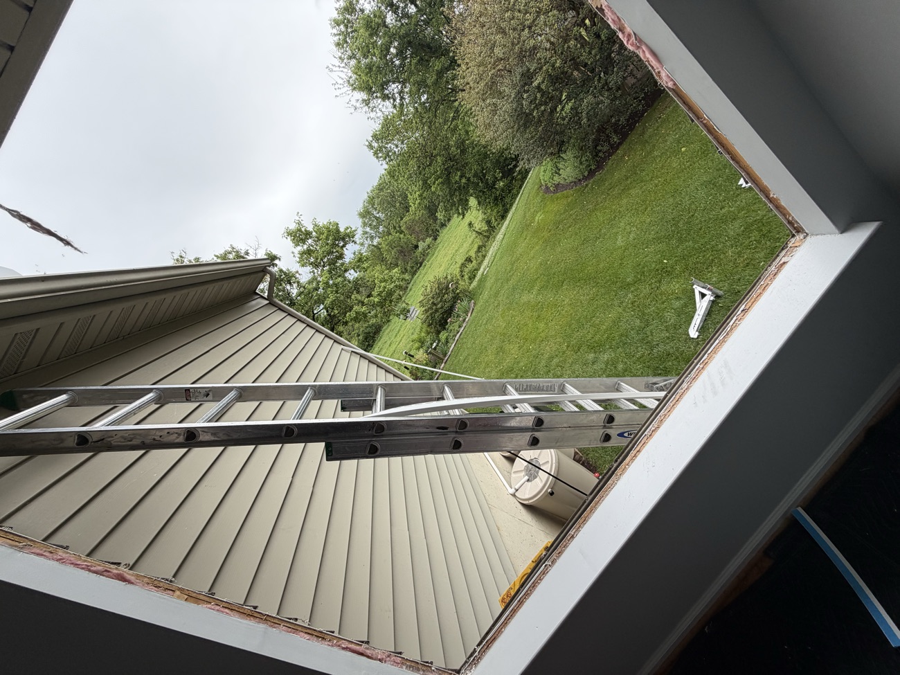 Crew fitting an upper-gable window on the two-storey home.