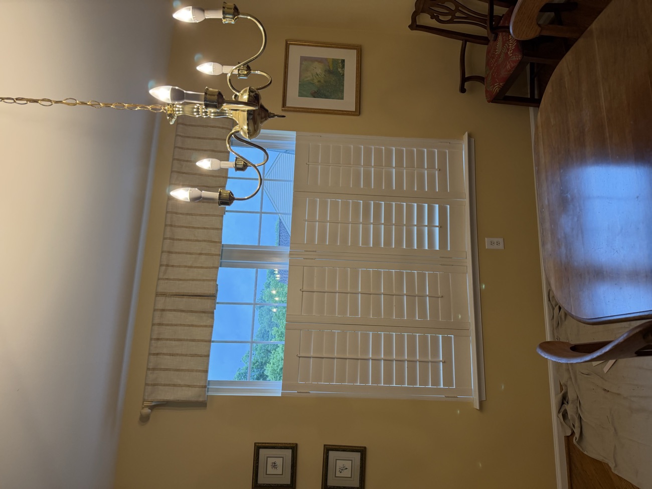 Interior dining room with the new window, furniture draped and protected.